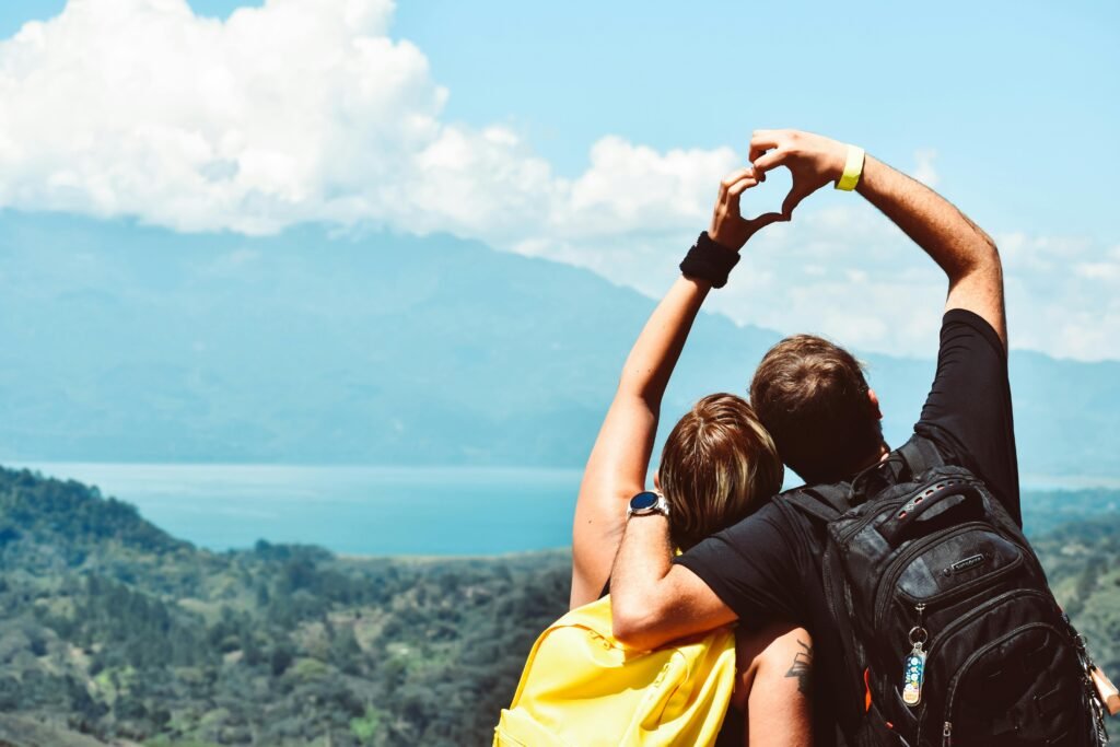 pexels-photo-1066801-1066801 Couple making a heart shape with arms over a beautiful view in Honduras.